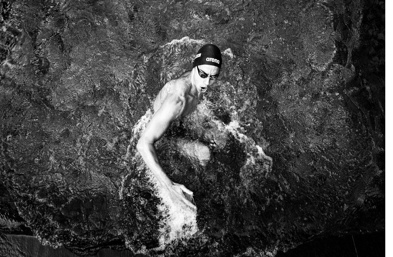 A swimmer surrounded by white water from above